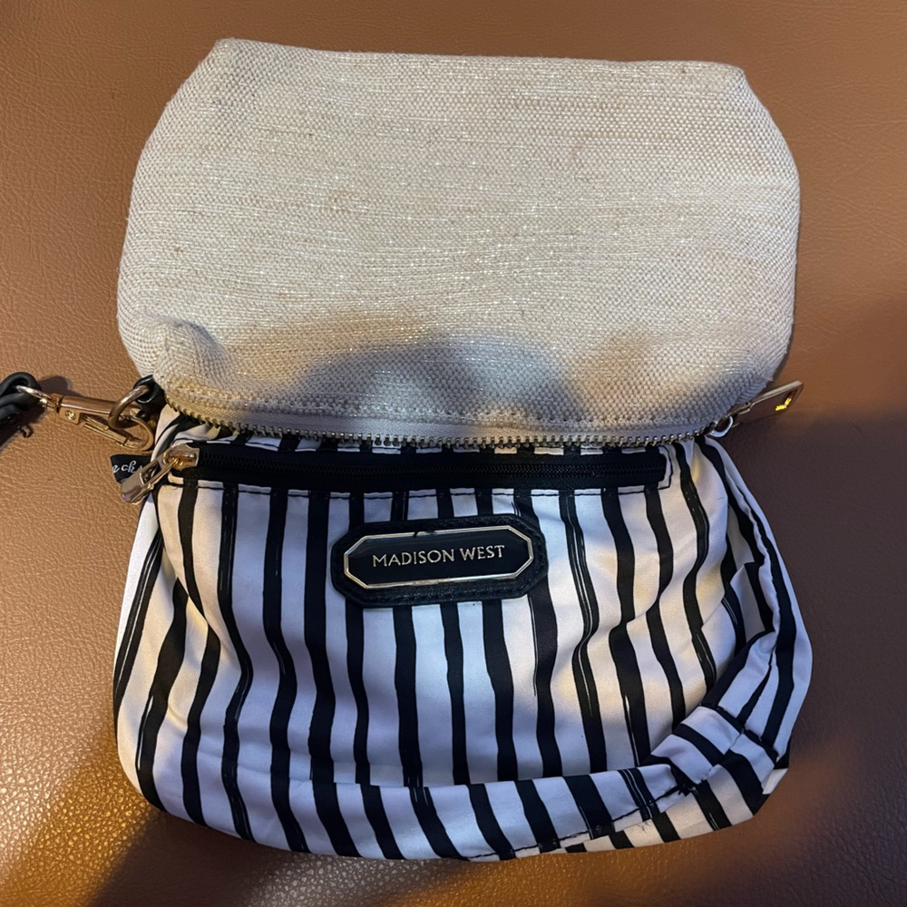 Madison West black and white striped makeup bag with zipper closure